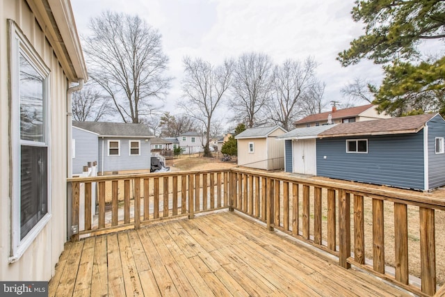 wooden terrace featuring an outbuilding