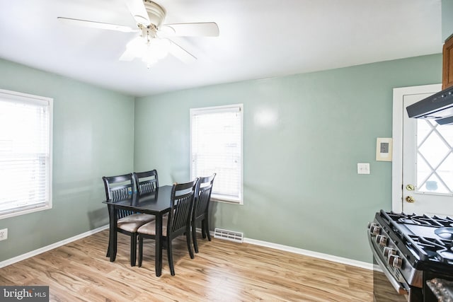 dining space featuring ceiling fan and light wood-type flooring