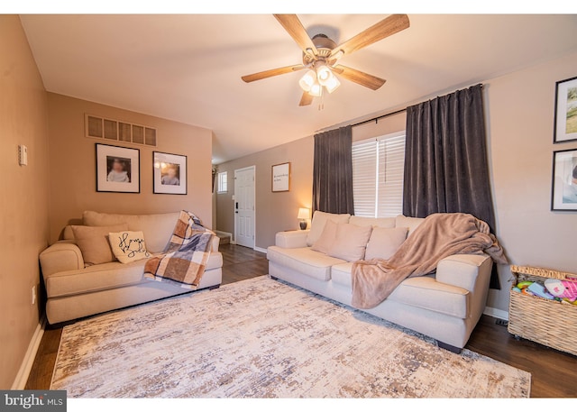 living room with dark hardwood / wood-style flooring and ceiling fan