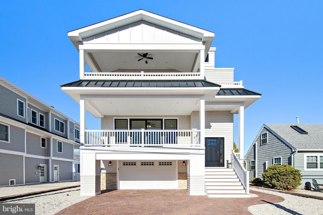 view of front of house with a garage and ceiling fan