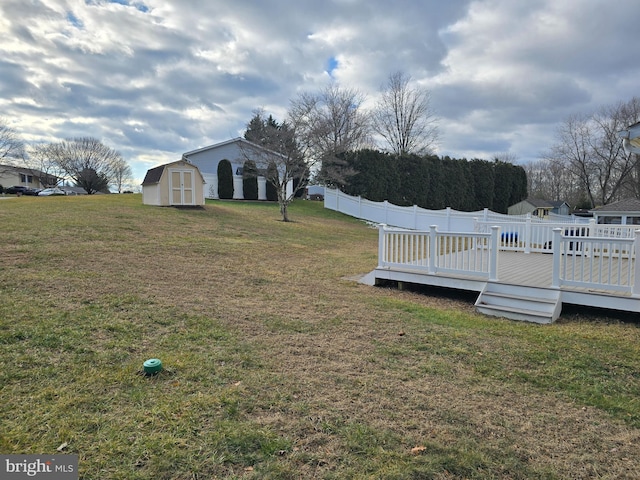 view of yard with a deck and a storage unit