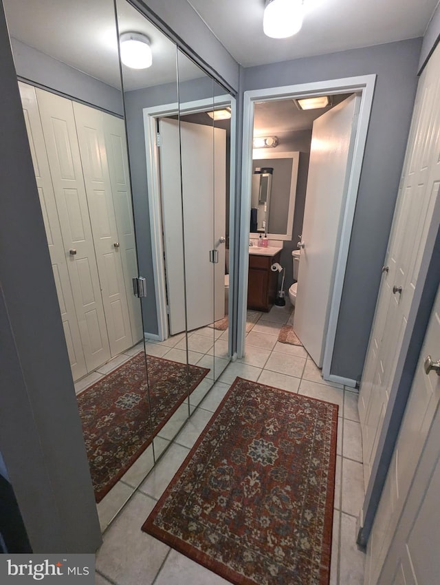 bathroom with vanity, a shower, tile patterned floors, and toilet