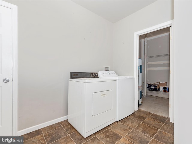 laundry room with washing machine and dryer, laundry area, and baseboards