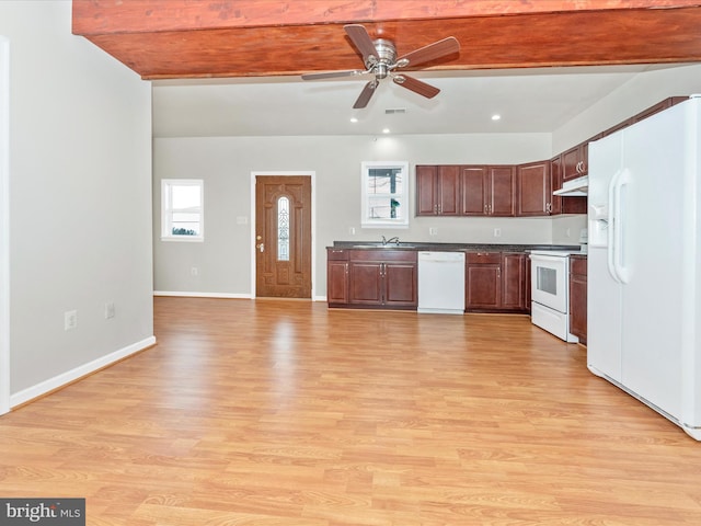 kitchen with under cabinet range hood, white appliances, baseboards, light wood-style floors, and dark countertops