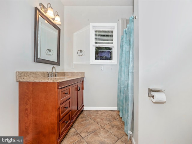 bathroom featuring baseboards, vanity, and tile patterned floors