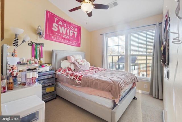 bedroom featuring visible vents, light carpet, vaulted ceiling, ceiling fan, and baseboards