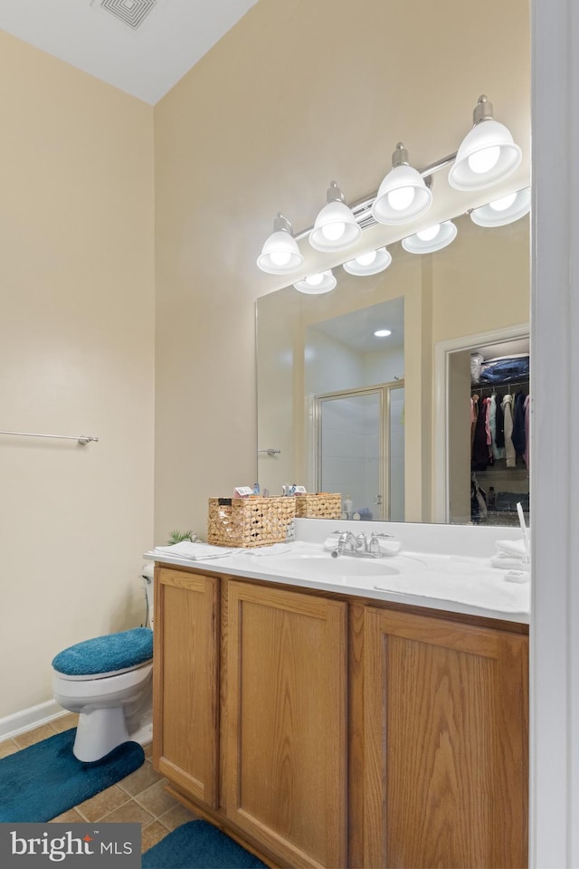 full bath featuring visible vents, a spacious closet, vanity, a shower stall, and tile patterned flooring