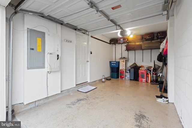 garage with concrete block wall, electric panel, and a garage door opener