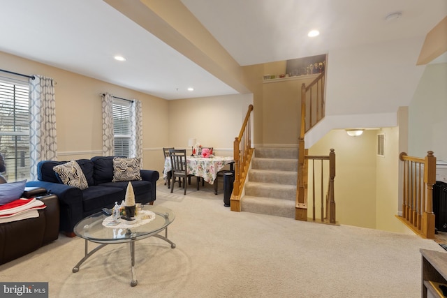 living room with recessed lighting, stairs, visible vents, and light colored carpet