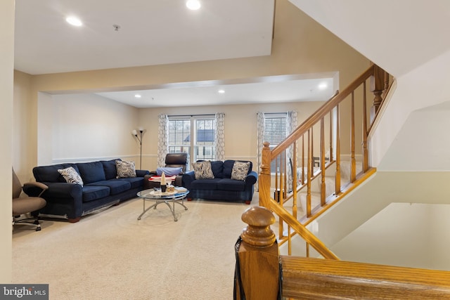 carpeted living room with stairs and recessed lighting