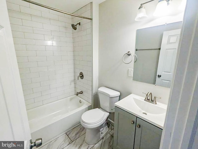 full bathroom featuring vanity, toilet, and tiled shower / bath