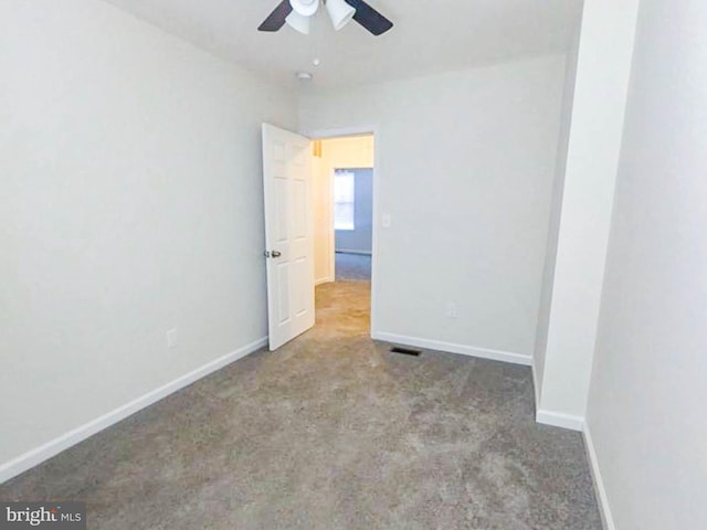 unfurnished room with light colored carpet and ceiling fan