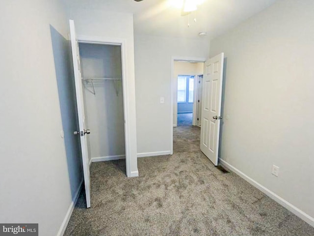 unfurnished bedroom featuring light colored carpet and a closet