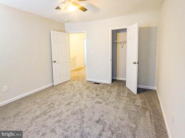 unfurnished bedroom with carpet, ceiling fan, and a closet