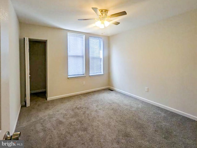 empty room featuring carpet floors and ceiling fan