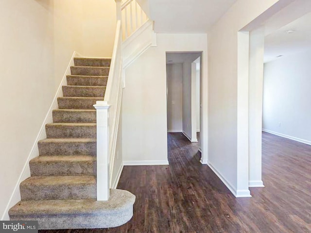 stairs with hardwood / wood-style floors