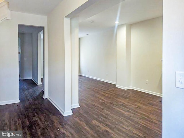 spare room featuring dark hardwood / wood-style flooring