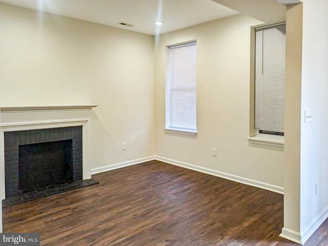 unfurnished living room featuring dark hardwood / wood-style floors and a fireplace