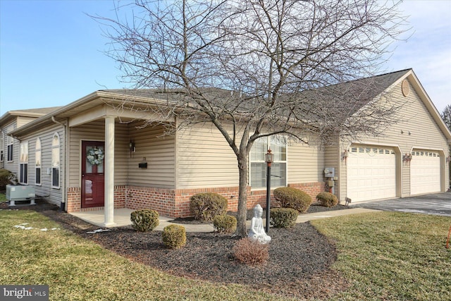 single story home featuring a garage and a front yard