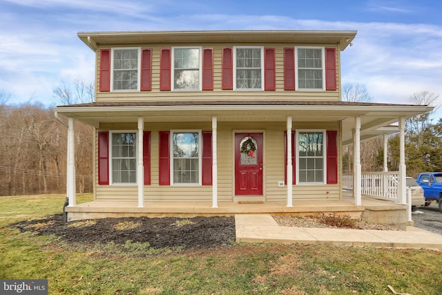 view of front of house with a porch and a front yard