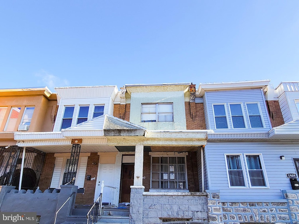 townhome / multi-family property featuring covered porch