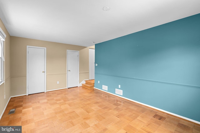 unfurnished bedroom with baseboards and visible vents