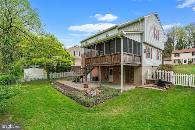 back of property featuring central air condition unit, a patio area, a lawn, stairway, and a sunroom