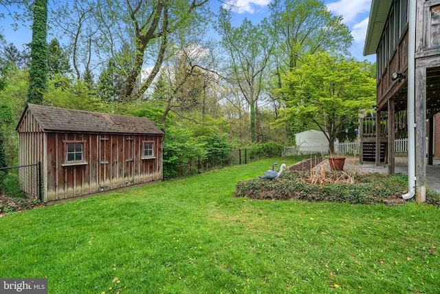 view of yard featuring a fenced backyard, an outbuilding, and a shed