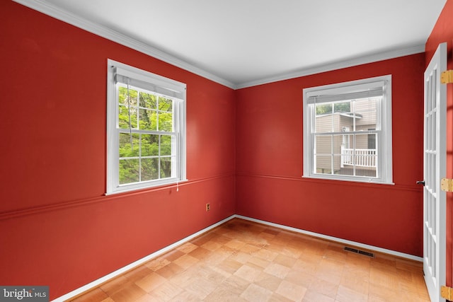 unfurnished room featuring visible vents, crown molding, baseboards, and light floors