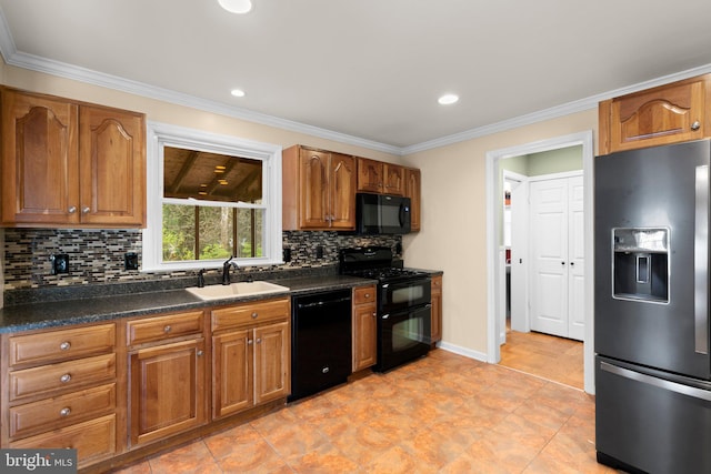 kitchen with a sink, tasteful backsplash, dark countertops, brown cabinetry, and black appliances