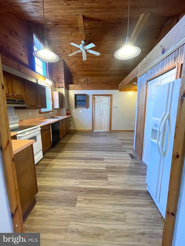 kitchen with white appliances, decorative light fixtures, high vaulted ceiling, and light wood-type flooring