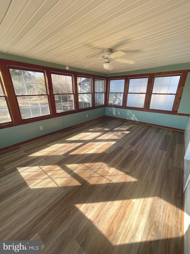 unfurnished sunroom with ceiling fan