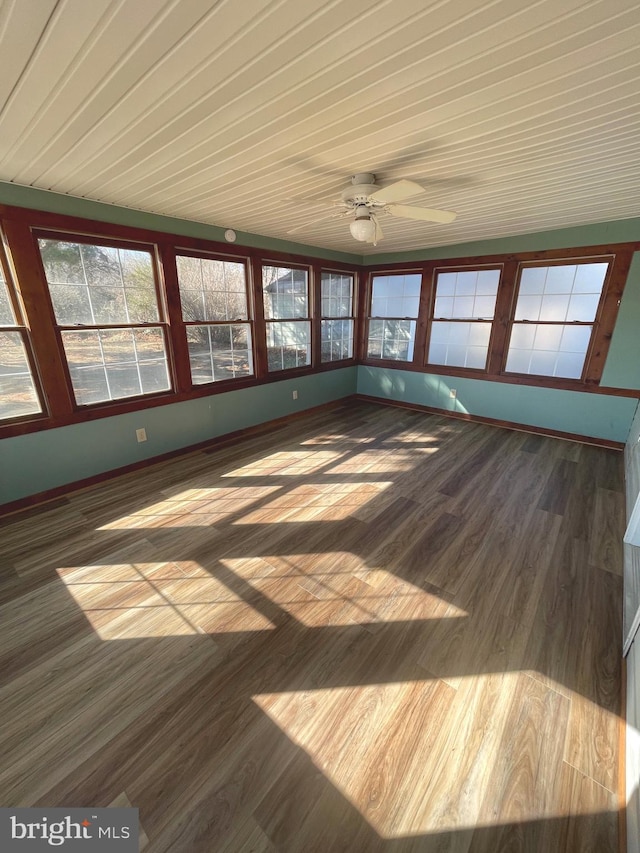 unfurnished sunroom featuring ceiling fan