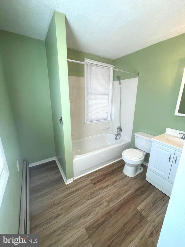 full bathroom featuring toilet, wood-type flooring,  shower combination, a textured ceiling, and vanity