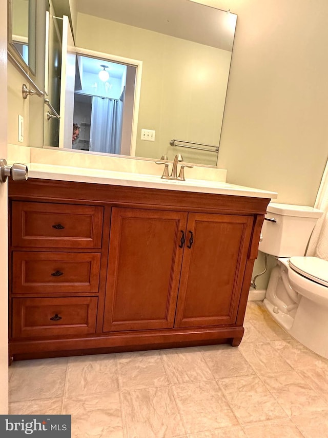 bathroom with vanity and toilet