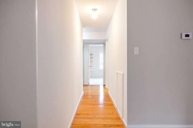 corridor with light hardwood / wood-style flooring