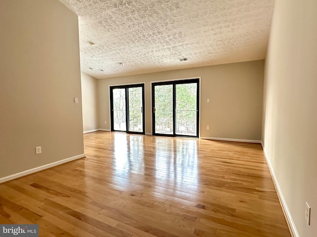 spare room with light hardwood / wood-style floors