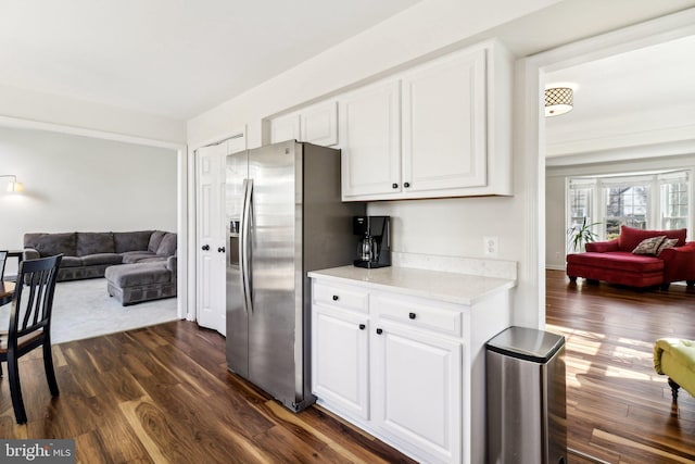 kitchen with white cabinetry, stainless steel fridge, and dark hardwood / wood-style flooring