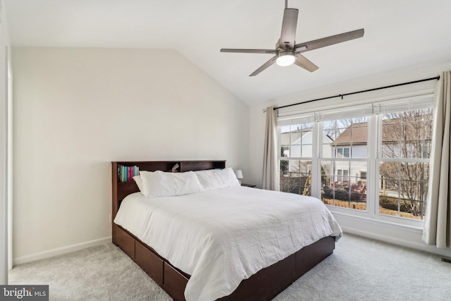 bedroom featuring lofted ceiling, light colored carpet, and ceiling fan