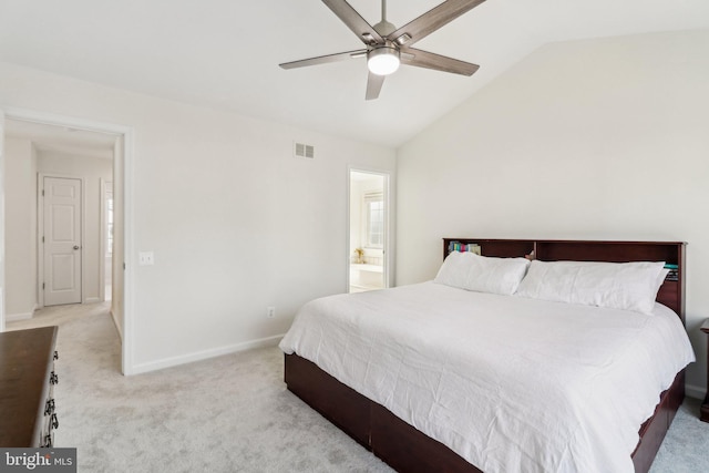 bedroom featuring ensuite bathroom, vaulted ceiling, ceiling fan, and light colored carpet