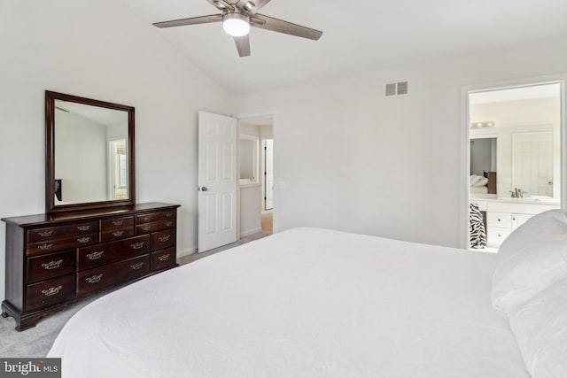 carpeted bedroom featuring ceiling fan, sink, vaulted ceiling, and connected bathroom