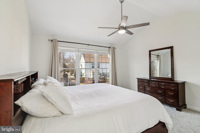 carpeted bedroom featuring multiple windows, vaulted ceiling, and ceiling fan