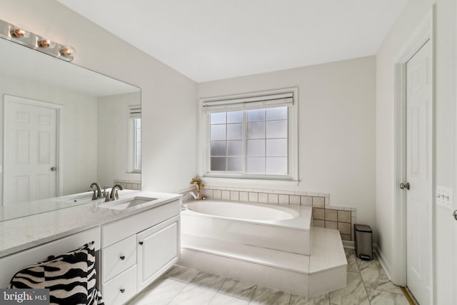 bathroom featuring vanity and a tub