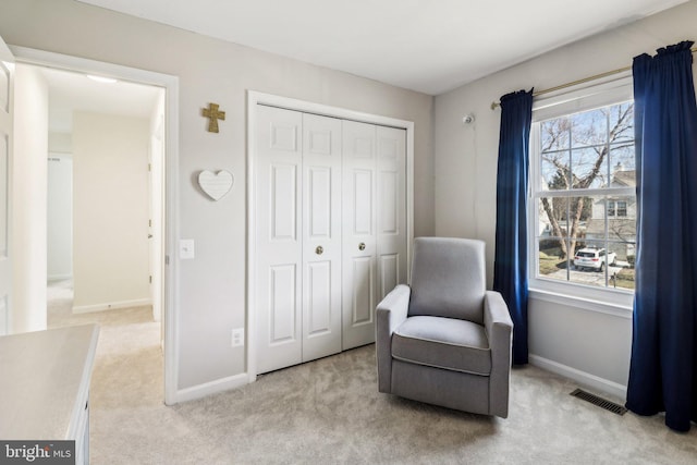 living area with light colored carpet