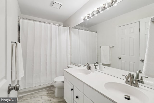 bathroom featuring toilet and vanity