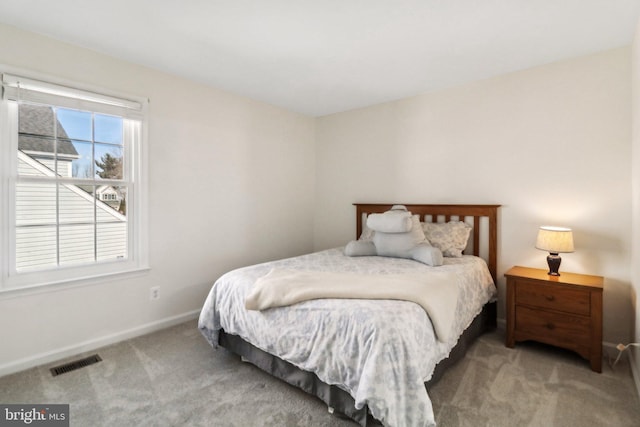 bedroom featuring light carpet