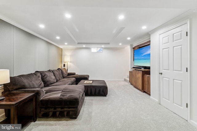 carpeted living room featuring ornamental molding and a raised ceiling