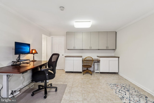 office space featuring light tile patterned floors, crown molding, and built in desk