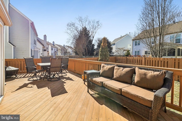 wooden terrace with an outdoor hangout area