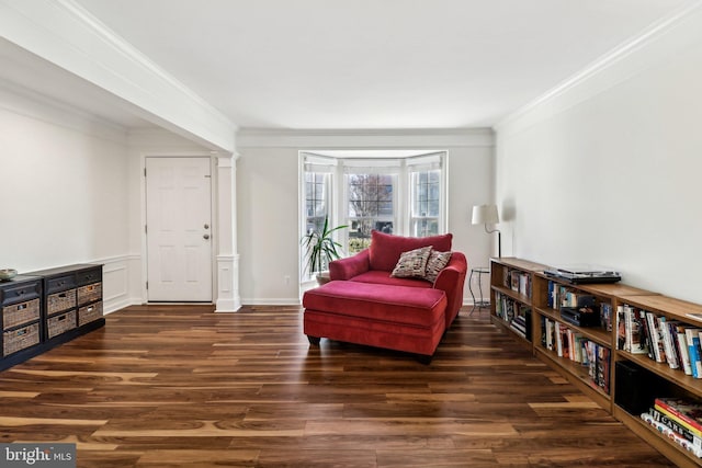 sitting room with crown molding and dark wood-type flooring